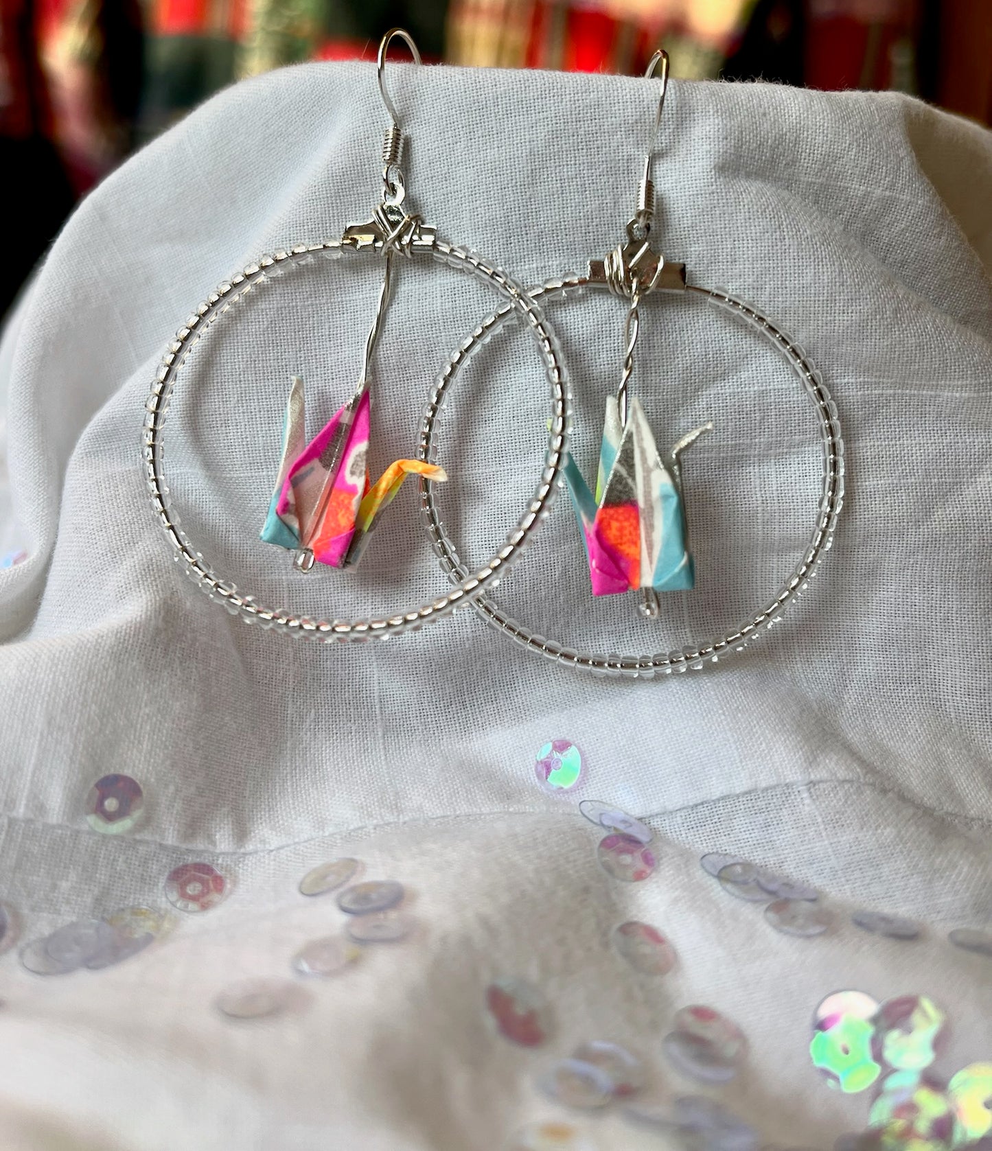 Silver hoop earrings with multi colored crane